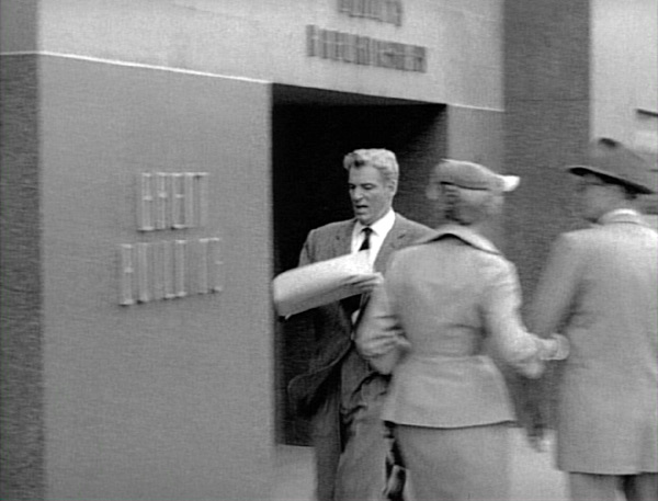 Paul running up the sidewalk to meet Perry outside The Brent Building.