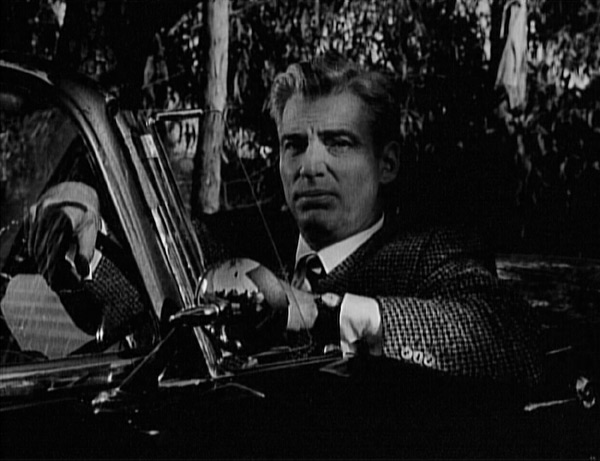 Perry and Della in the darkened front offices, their silhouettes outlined by light coming through the doorway