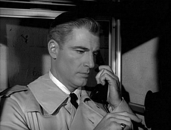 Paul in a telephone booth dialing his exchange
